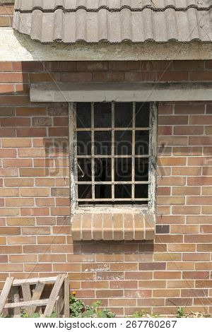 A Close Up View Of The Side Window Meatal Frame Of An Abandeded Building