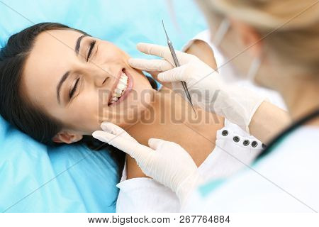 Young Female Patient Visiting Dentist Office.beautiful Woman With Healthy Straight White Teeth Sitti