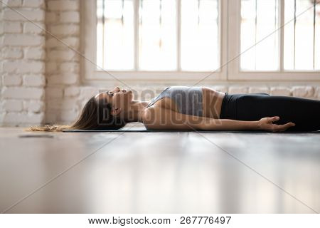 Young Sporty Attractive Woman Practicing Yoga, Doing Dead Body