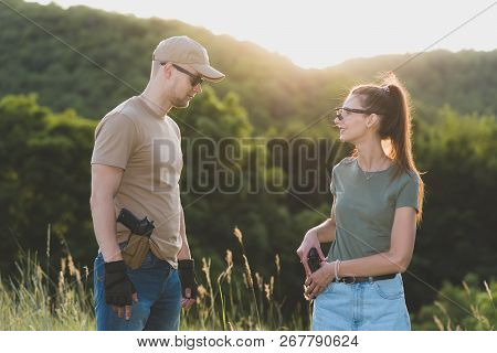 The Instructor Teaches The Girl To Shoot A Pistol At The Range