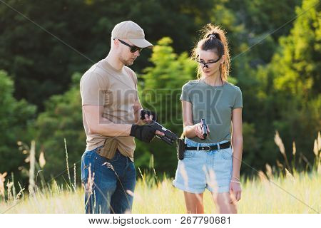 The Instructor Teaches The Girl To Shoot A Pistol At The Range