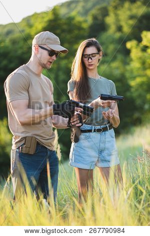 The Instructor Teaches The Girl To Shoot A Pistol At The Range