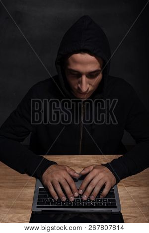 Hacker In Black Hoodie Using Laptop, Cuber Security Concept