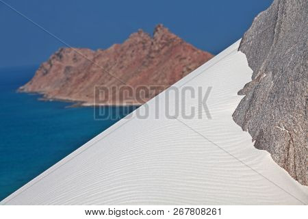 Abd al Kuri island rocks covered with white coral sand - Socotra archipelago, Yemen