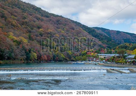 Togetsukyo Bridge In Arashiyama, Kyoto Prefecture, Japan During Koyo Vibrant Autumn Foliage Festival