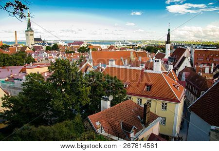 Panoramic View Of Old Town Of Tallinn With Traditional Red Tile Roofs, Medieval Churches, Towers And