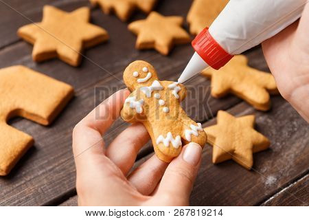 Confectioner Decorating Gingerman With Royal Icing, Closeup