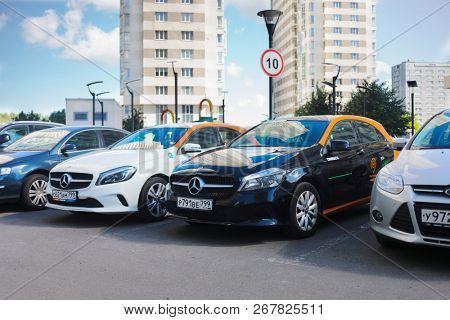 MOSCOW - JUN 20, 2018: Two Mercedes Benz cars of Moscow carsharing company You drive among other cars near buildings, carsharing is system of short-term car rental