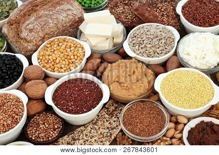 Vegan health food with tofu bean curd, legumes, nuts, seeds, cereals vegetables, grains,  almond yoghurt, wholegrain bread and crackers. High in antioxidants, omega 3, protein and dietary fibre.