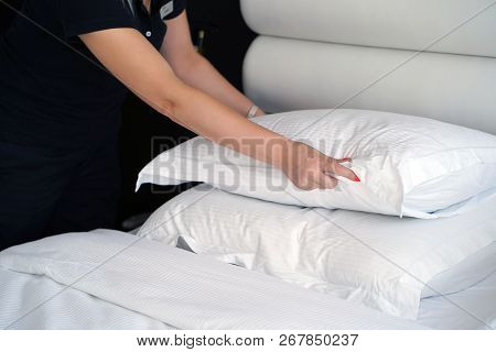 Maid Making Bed In Hotel Room. Housekeeper Making Bed