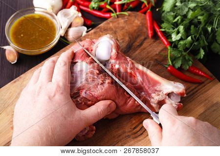 Chef Butcher Cutting Lamb Meat With Knife On Kitchen, Cooking Proteine Food