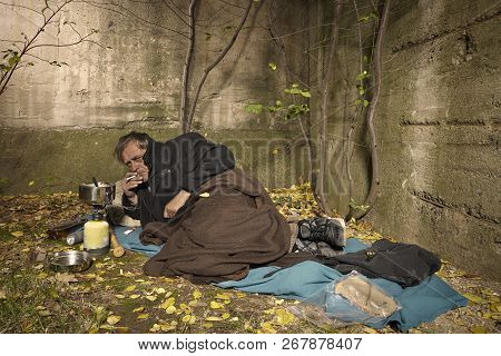 Ugly Pauper Man Living Outdoor Sleeping, Relaxing And Laying Alone On Hidden Urban Place