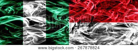 Nigeria, Nigerian Vs Monaco, Monacan Smoke Flags Placed Side By Side. Thick Abstract Colored Silky S