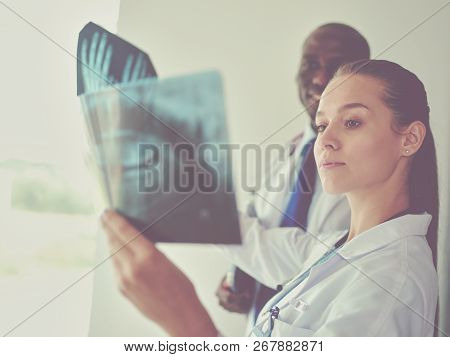 Doctors Analyzing An X-ray In A Meting. Doctors