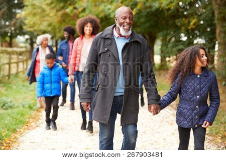 Multi Generation Family On Autumn Walk In Countryside Together
