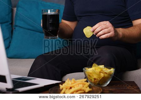 Mindless Snacking, Overeating, Lack Of Physical Activity, Laziness, Homebody. Fat Overweight Man Eng
