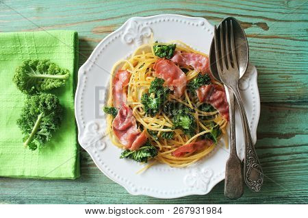 Delicious Spicy Linguine Pasta With Fried Cabbage Kale, Bacon, Garlic And Parmesan On A White Plate 