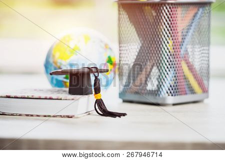 Graduate Or Education Knowledge Learning Study Abroad Concept : Graduation Cap On Book With Blur Of 