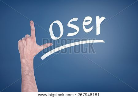 A Male Hand Making A L Letter That Starts A Word Loser On A Blackboard.