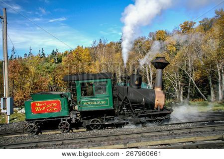 MOUNT WASHINGTON COG RAILWAY, BRETTON WOODS, NH - October 6, 2007:  Mount Washington cog railway locomotive in foliage season with blue sky.