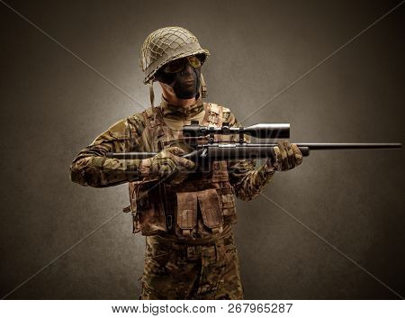 Soldier agent in a dark room with arms on his hand and gas mask