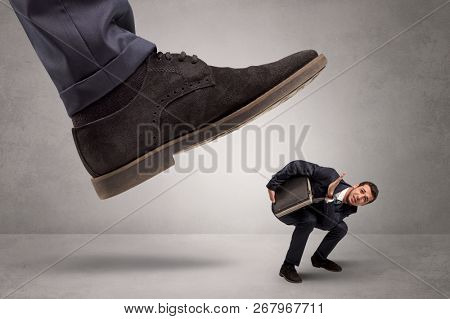 Young businessman illustrated inconsiderable by being trampled