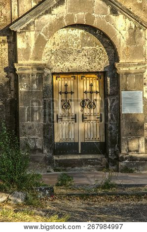 Side Wooden Door With Wrought Iron Crosses In The Monastery Saghmosavank, Standing On The Edge Of Th