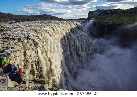 Tourist On The Edg Of Detifoss Waterfall. One Of The Best Attraction In Iceland. Dettifoss Is The Mo