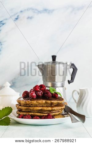 Gluten-free Green Buckwheat Pancakes With Fresh Berries And Maple Syrup. Delicious Vegan Breakfast W