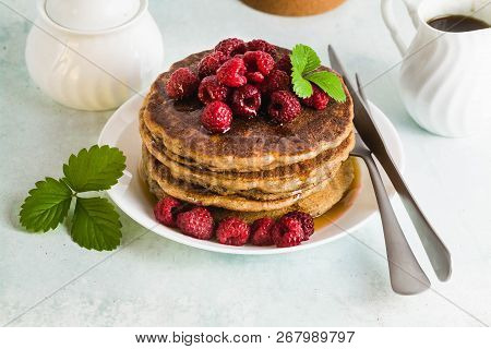 Gluten-free Green Buckwheat Pancakes With Fresh Berries And Maple Syrup. Delicious Vegan Breakfast W