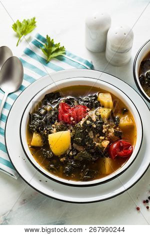 Vegan Winter Kale Soup With Buckwheat , Cherry Tomatoes And Potatoes. Tasty Full Vegetable Food For