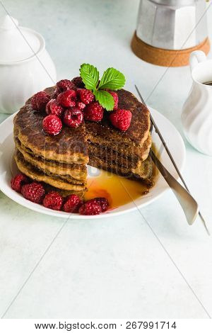 Gluten-free Green Buckwheat Pancakes With Fresh Berries And Maple Syrup. Delicious Vegan Breakfast W