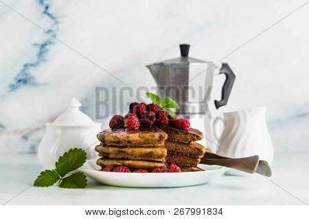 Gluten-free Green Buckwheat Pancakes With Fresh Berries And Maple Syrup. Delicious Vegan Breakfast W