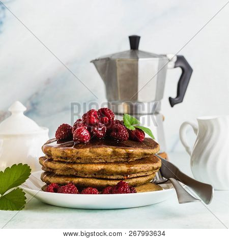 Gluten-free Green Buckwheat Pancakes With Fresh Berries And Maple Syrup. Delicious Vegan Breakfast W