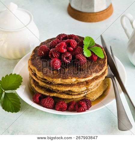 Gluten-free Green Buckwheat Pancakes With Fresh Berries And Maple Syrup. Delicious Vegan Breakfast W