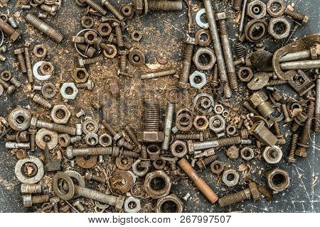Old Worn Metal Bolts And Screw-nuts In Set. Spent Fasteners Close-up.