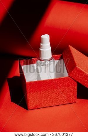 Post-covid New Normal Concept With Alcohol Hand Sanitizing Spray As Gift In Red Gift Box. How Will T