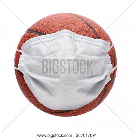 Covid-19 and Sports Concept. A basketball with Surgical Mask, isolated onb white