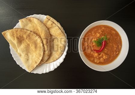 Famous Traditional Arabic Cuisine - Peeled Fava Beans With Chili In White Bowl And Pita Bread On Dar