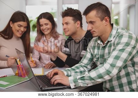 Group Of Young People Studying Together At College Classroom