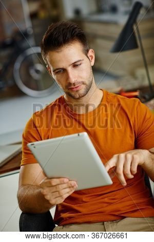 Young man using tablet computer.