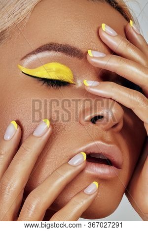 Beautiful Tanned Skin Woman. Sunburnt Girl Face With Natural Bronzed Make-up, Yellow Manicure. Sexy