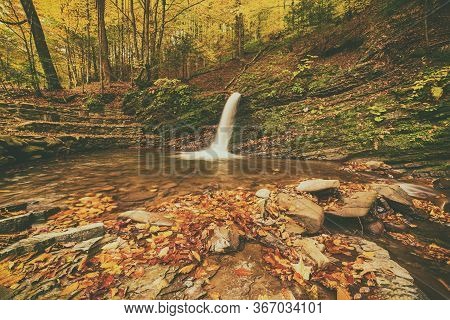 Autumn Mountain Waterfall Stream In The Rocks With Colorful Red Fallen Dry Leaves, Natural Seasonal 