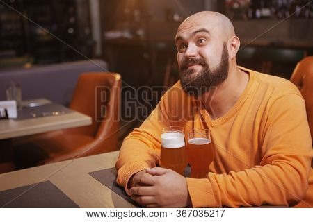 Bearded Man Enjoying Drinking Beer At The Pub