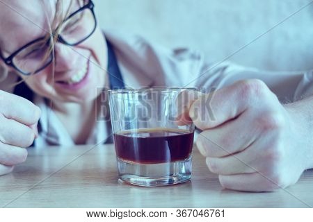 A Drunk Man In A Shirt And Tie Is Banging His Fist On The Table. Toned. Close Up.