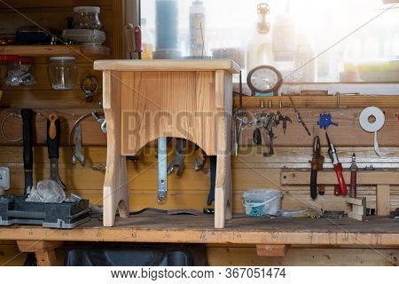 Oak Wooden Stool Chair After Resoring And Repair At Carpentry Woodwork Workshop With Tools And Sawdu