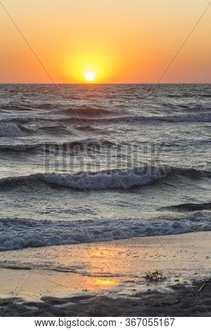 An Orange Sunset Evening Over The Black Sea With Big Dark Waves, Kinburn Foreland Shore, Ukraine