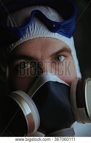 COVID-19 or 2019-nCoV. Close-up portrait of a scientist microbiologist in respiratory mask. Pandemic.