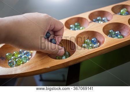 Hand Hold Glass Ball In Kalaha Game