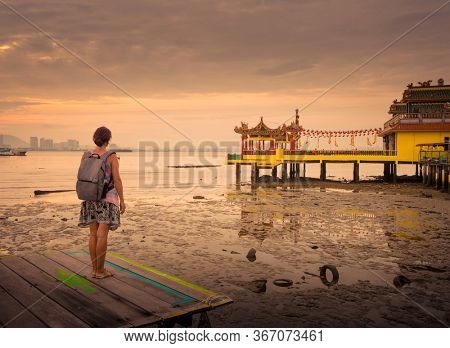 Tourist  at Yeoh jetty at sunrise, Georgetown, Penang, Malaysia. 